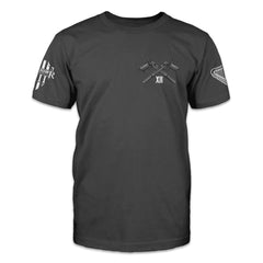 A dark gray t-shirt with two pistol printed on the front. 