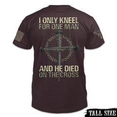 A burgundy tall size shirt with the words "I only kneel for one man, and he died on the cross" with a cross printed on the back of the shirt.