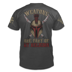 A dark grey t-shirt with the words "Weapons are part of my religion" with a spartan helmet printed on the back of the  shirt.
