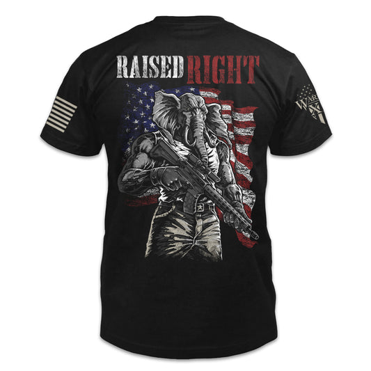 A black t-shirt with the words "Raised Right" with an elephant holding a gun in front of the American flag printed on the back of the  shirt.