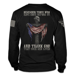 A black long sleeve shirt with the words "Remember those who have gone before us, and thank God that such men lived" with a cross holding a helmet and American flag printed on the back of the shirt.