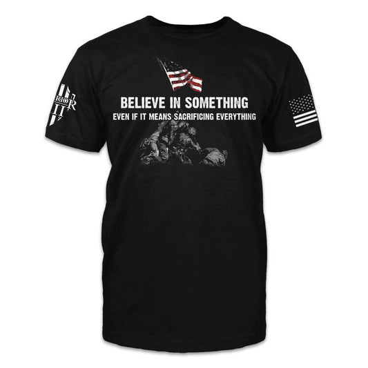 A black t-shirt with the words "Believe In Something, Even If It Means Sacrificing Everything" with soldiers putting up the American flag printed on the front of the  shirt.