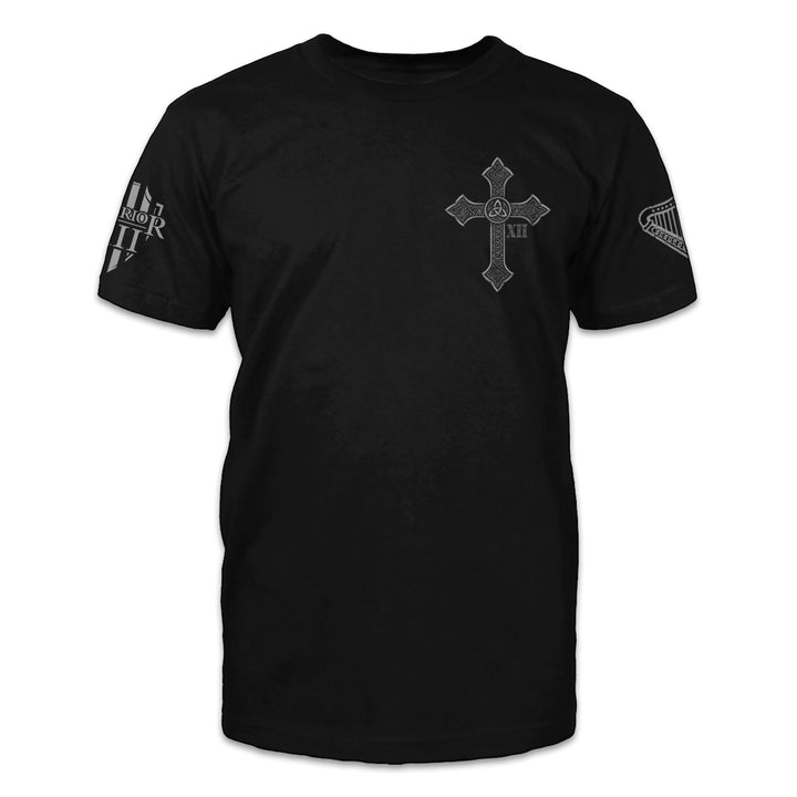 A black t-shirt with across printed on the front of the shirt. 