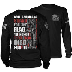 Front and back black long sleeve shirt with the words "Real Americans Stand For The Flag To Honor Those Who Died For It!" printed on the shirt.