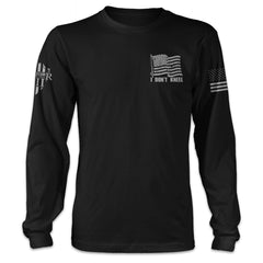A black long sleeve shirt with the words "I don't kneel" and an American flag printed on the front.
