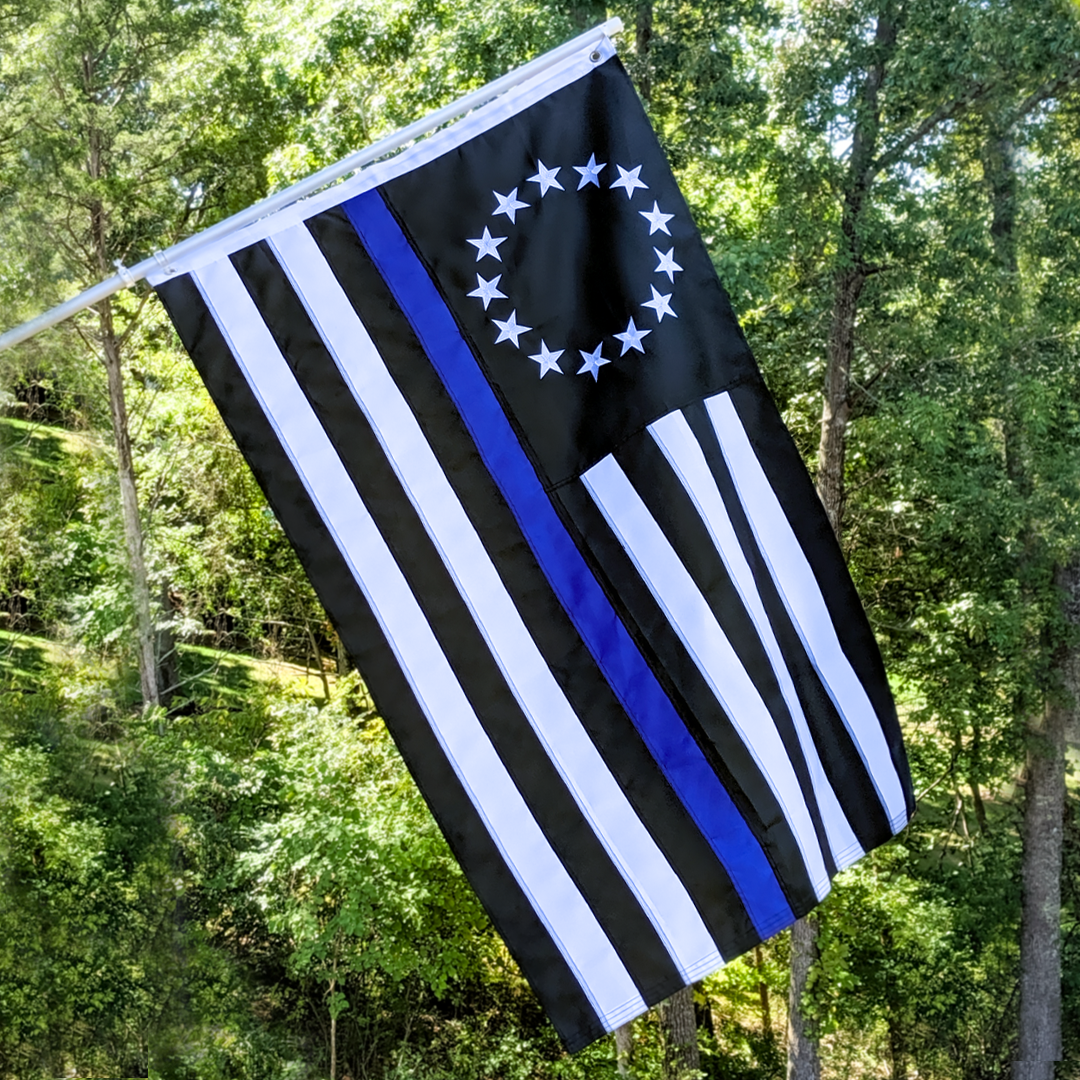Embroidered Thin Blue Line Betsy Ross Flag hanging from a flag pole.