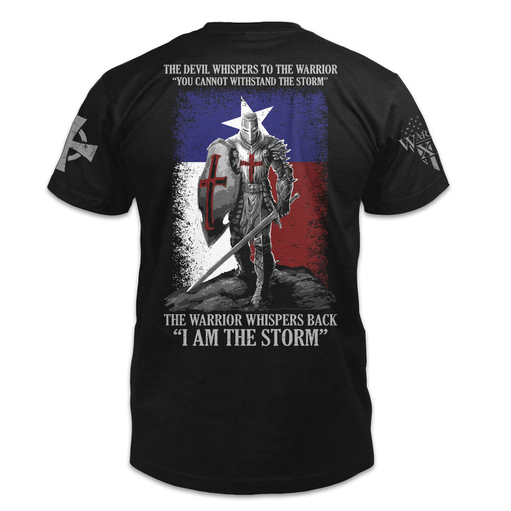 A black t-shirt with the words "The Devil whispers to the Warrior, "You cannot withstand the storm." The Warrior whispers back "I am the storm." with a warrior printed on the back of the  shirt.