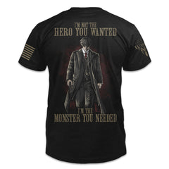 A black t-shirt with the words "I'm not the hero you wanted, I'm the monster you needed" with a Tommy Shelby outline printed on the back of the  shirt.