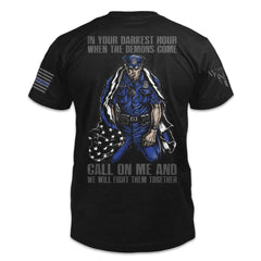 A black t-shirt with the words "In your darkest hour when the demons come, call on me and we will fight them together" with a police officer printed on the back of the shirt.