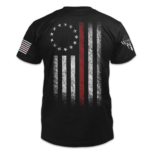 A black t-shirt that features a Thin Red Line Betsy Ross Flag shirt printed on the back of the shirt.