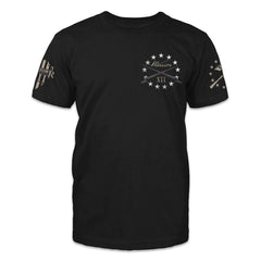 A black t-shirt with stars and two bayonets crossed over printed on the front left chest.