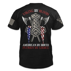 A black t-shirt with the words "Viking by blood, American by birth, patriot by choice" with viking axes printed and an American flag printed on the back of the shirt.