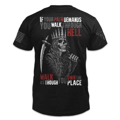 A black t-shirt with the words "If your path demands you walk through hell, walk as though you own the place" and a reaper printed on the back of the  shirt.